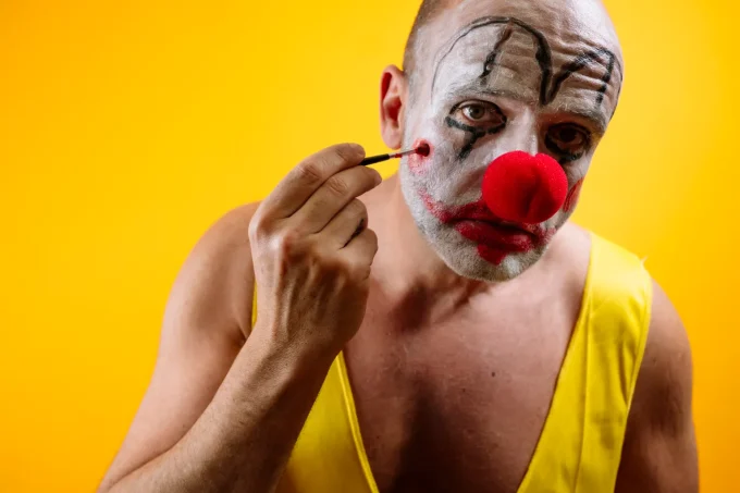 sad-clown-putting-on-makeup-GettyImages-2187826511